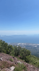 Tourist documents Mount Vesuvius crater and Naples bay views