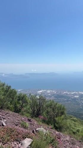 Tourist documents Mount Vesuvius crater and Naples bay views