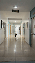 Toddler runs through hallway in Marunji, India