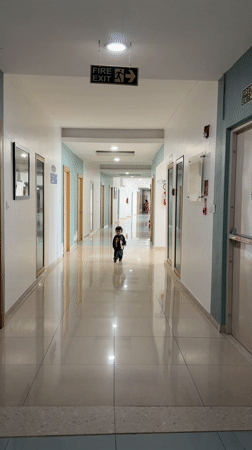 Toddler runs through hallway in Marunji, India