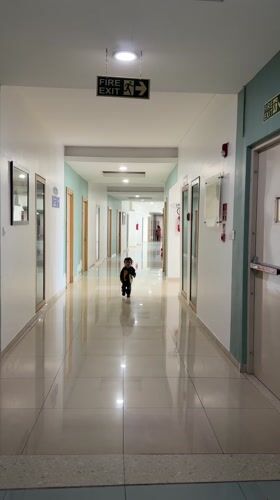 Toddler runs through hallway in Marunji, India
