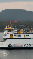 Melaya ferry terminal at dusk — boats, ramps, and port activity