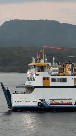 Melaya ferry terminal at dusk — boats, ramps, and port activity