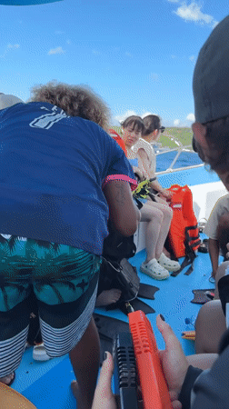 Snorkeling group prepares gear on boat in Kampung Toyapakeh