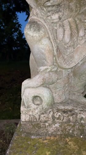 Ancient statue and motorcycle rider documented in Blahbatuh