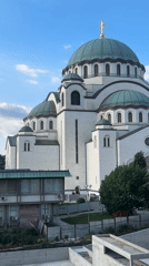 White cathedral with green domes observed in Belgrade district