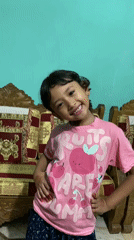 Young girl poses for photos at home in Dhaka