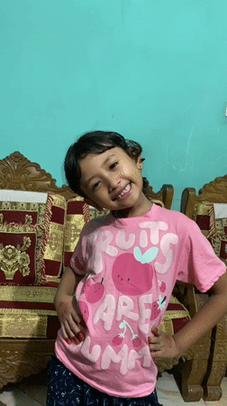 Young girl poses for photos at home in Dhaka