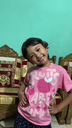 Young girl poses for photos at home in Dhaka