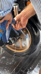 Early morning motorcycle wash documented in Denpasar, Indonesia