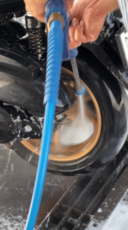 Early morning motorcycle wash documented in Denpasar, Indonesia