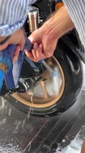 Early morning motorcycle wash documented in Denpasar, Indonesia