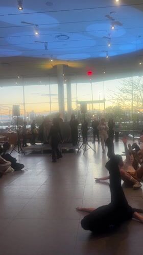 Dance performance with colored lighting in NYC studio space