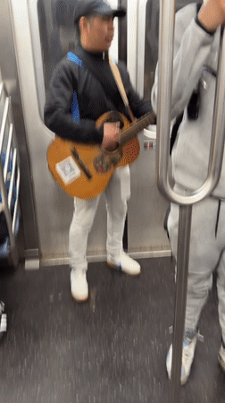 Musician performs acoustic set for NYC subway passengers