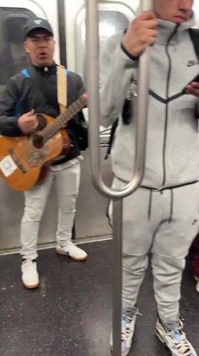Musician performs acoustic set for NYC subway passengers
