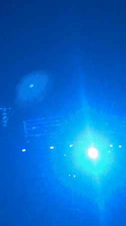 Nighttime concert in Tel Aviv, screens glowing blue