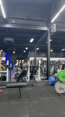 Man uses phone in early morning gym session