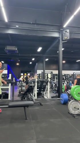 Man uses phone in early morning gym session