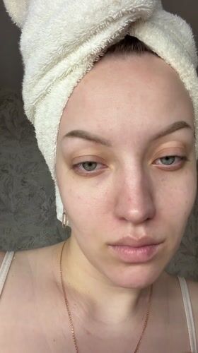 Woman performs morning skincare routine in Reshetnikovo, Russia