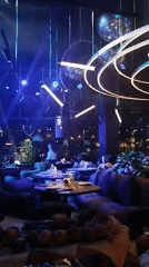 Dimly lit upscale restaurant with patrons dining