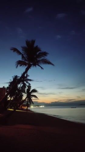 Dusk beach scene documented in Baan Mae Nam, Thailand