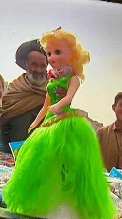 Early morning New York scenes capture doll at market, person watching phone