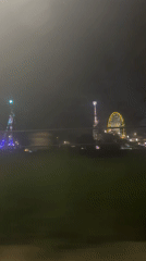 Night fairground with illuminated Ferris wheel captured in Stuttgart