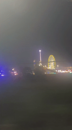 Night fairground with illuminated Ferris wheel captured in Stuttgart