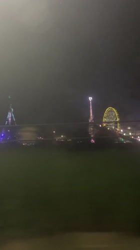 Night fairground with illuminated Ferris wheel captured in Stuttgart