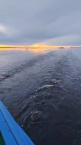 Boat journey recorded during twilight hours near Bereg, Russia