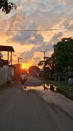 Golden hour settles over a quiet village road in Lhokseumawe