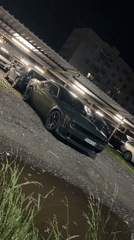 Evening rainfall documentation in Sofia features green Dodge Challenger