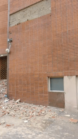 Caracas shopping center facade collapses, debris scattered at entrance