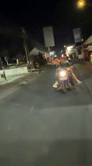 Four riders share single red scooter in North Kuta