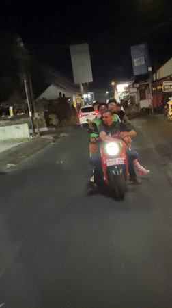 Four riders share single red scooter in North Kuta