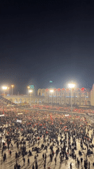 Large crowd gathers in Tehran plaza on summer evening