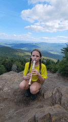Playing recorder on a rocky outcrop in Sutton, Canada