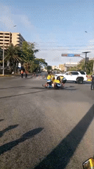 Yellow-shirted group gathers in Venezuela street intersection with inflatable raft