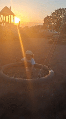 Child plays at sunset playground in Timmolovo, Russia