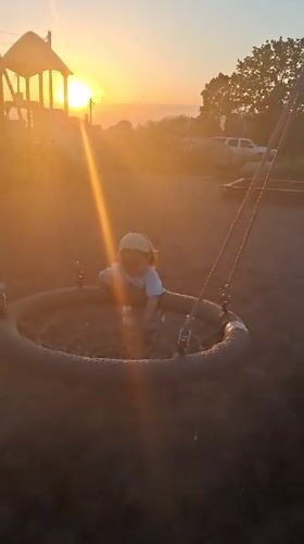 Child plays at sunset playground in Timmolovo, Russia