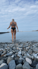Beach walk with arms raised in Sochi waters