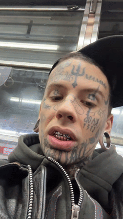 Heavily tattooed face, Buenos Aires streets, late night