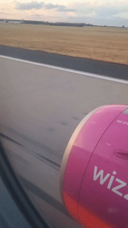 Wizz Air departure from taxi to climb, window seat view