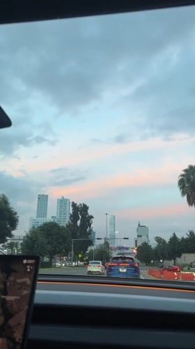 Evening drive through Tlaxcalancingo under a pink-clouded sky