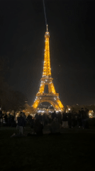 Evening crowds gather for Eiffel Tower's nightly illumination display