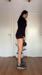 Woman conducts early morning home workout with dog in Chaikovsky