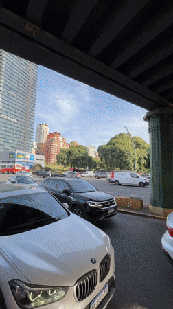 Traffic flows beneath green bridge in Buenos Aires