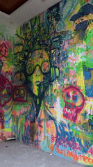 Tourists take selfies at colorful graffiti art spot in Ubud