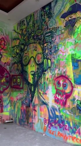 Tourists take selfies at colorful graffiti art spot in Ubud