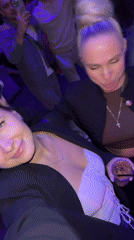 Two women sing along to music at Odintsovo nightclub